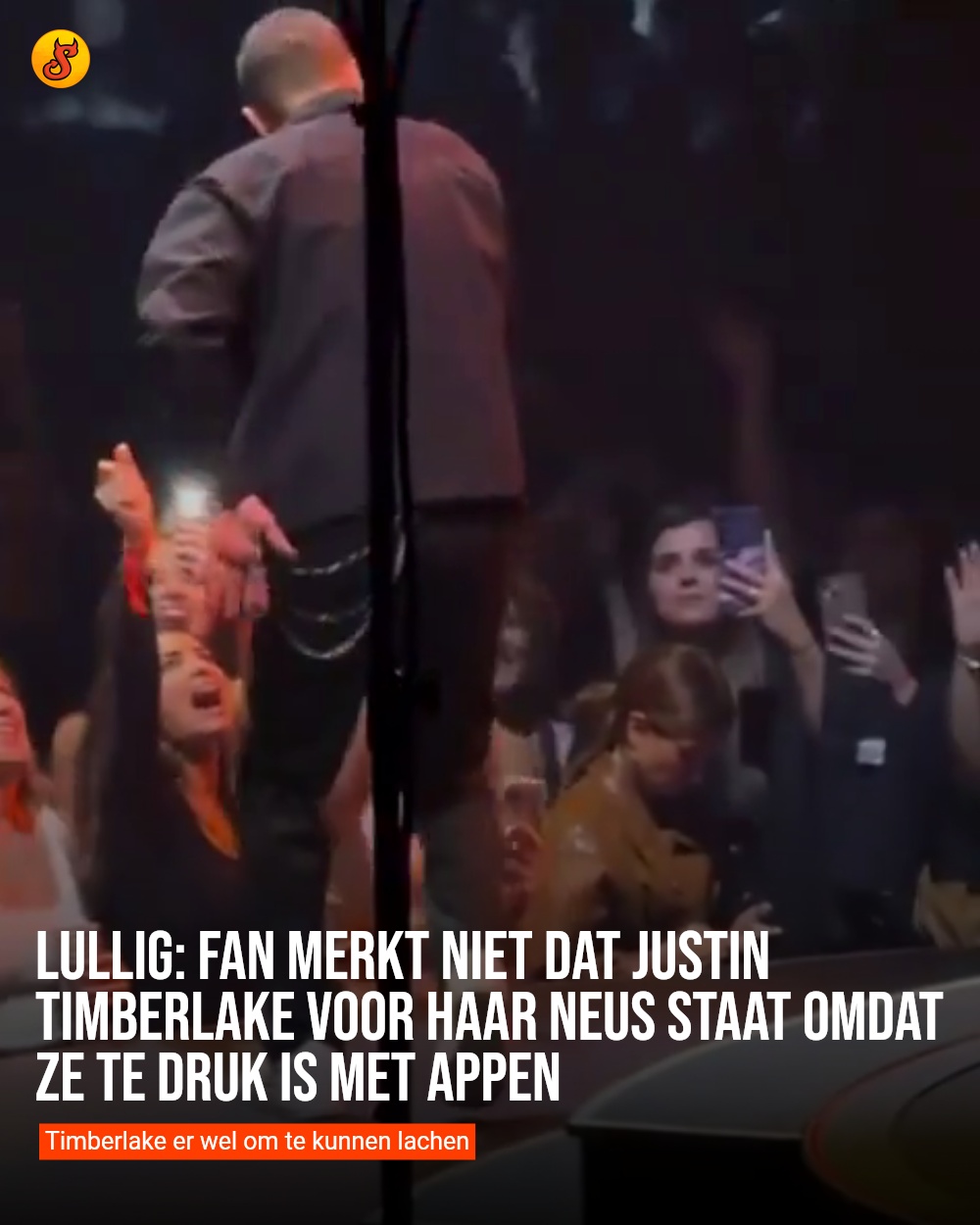 Lullig: Fan merkt niet dat Justin Timberlake voor haar neus staat omdat ze te druk is met appen