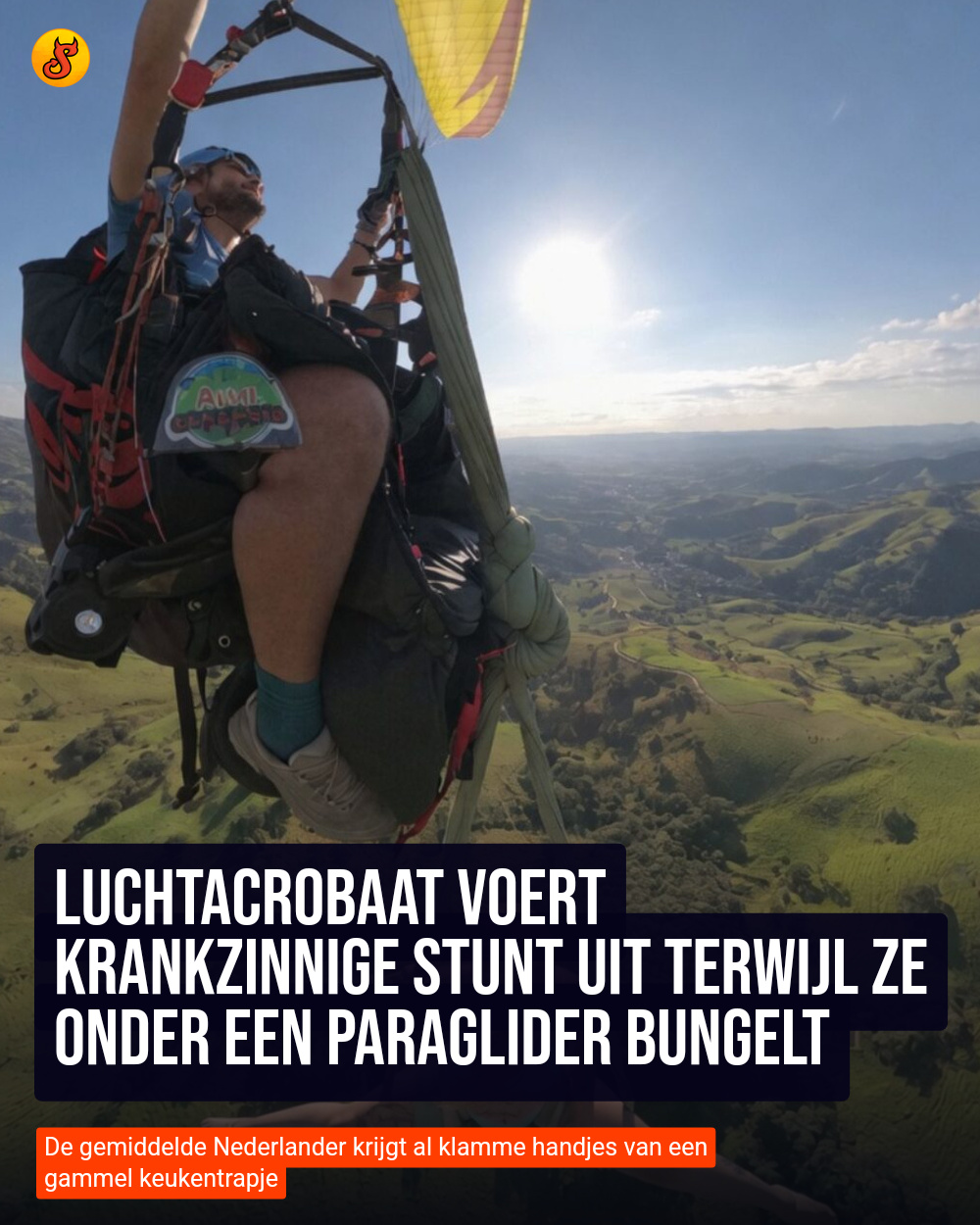 Luchtacrobaat voert krankzinnige stunt uit terwijl ze onder een paraglider bungelt