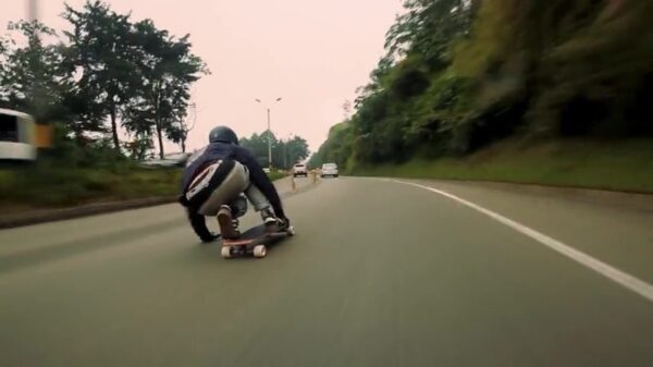 Garret Smith joekelt met een noodgang op zijn longboard over de Colombiaanse wegen