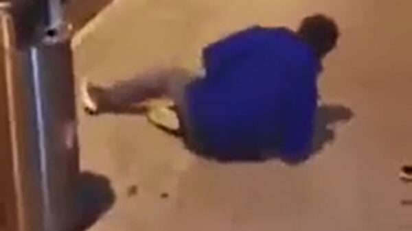 Beginnend parkourbinkje omhelst paal met zijn maag