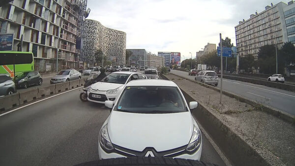 Fransoos wacht op het juiste moment om zijn auto voor een motor te gooien