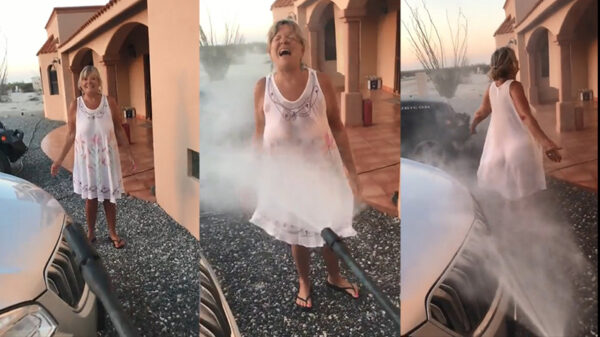 Buurvrouw in nietsverhullend jurkje zoekt wat verkoeling