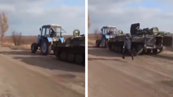 Oekraïense boer met ballen van staal jat een Russische tank met zijn trekker