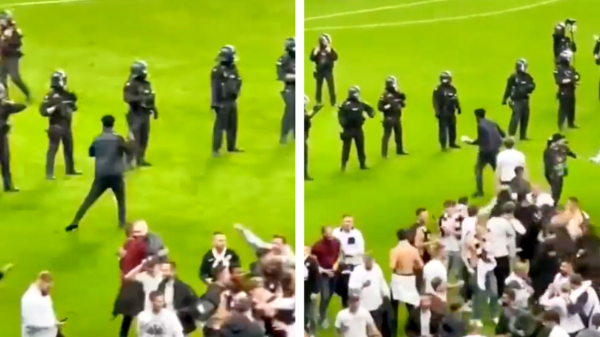 Hooligan van Eintracht Frankfurt daagt ME'ers uit en krijgt knuppel in z'n nek