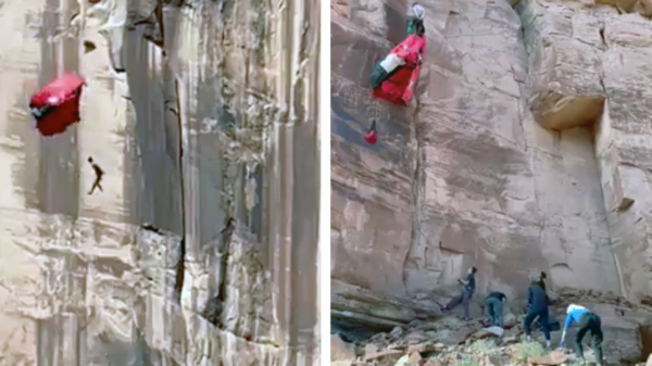 Basejumper in Utah klapt tegen een rotswand en bungelt aan zijn parachute