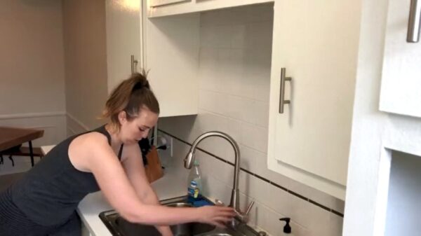 De SFW-versie van een vrouw die met haar hand vastzit in de gootsteen