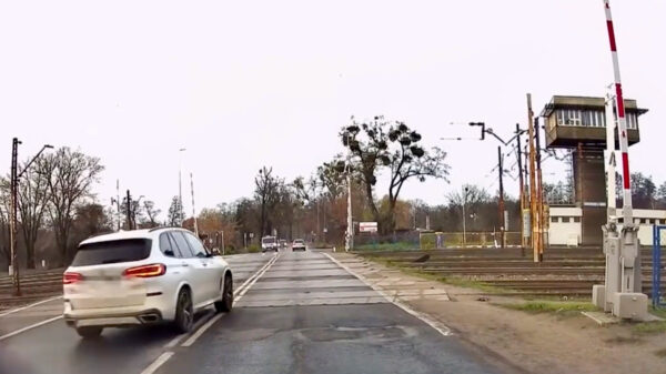 Instant karma voor vent die last minute over spoorwegovergang knalt