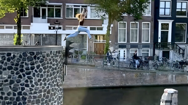 Franse parkourprofessional Lola Roy springt van een brug in Amsterdam