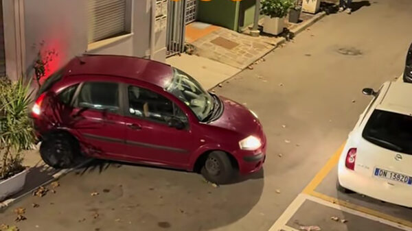 Vrouw stuntelt eindeloos met klein koekblik in smalle Italiaanse straat