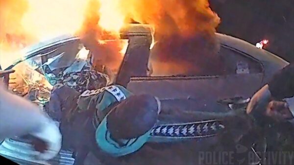 Politieagenten redden man die klem zit in een brandende auto