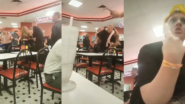 Kerel draagt zijn dronken vriendin als een holbewoner het fastfoodrestaurant uit