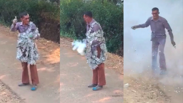 Gekke Aziaat viert oud & nieuw door een lading vuurwerk over zichzelf te hangen